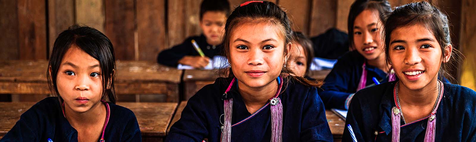 Group of smiling students in a classroom.